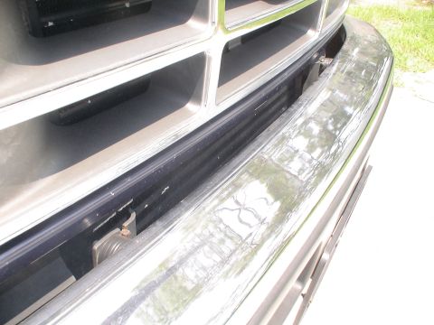1993 Ford C-350 (Centurion Conversions) - Close-up of the front grille and chrome bumper of a 1993 Ford C-350 (Centurion Conversions).