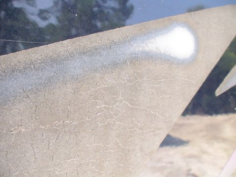 1993 Ford C-350 (Centurion Conversions) - Close-up of cracked paint on a vehicle body panel, showing wear and tear.