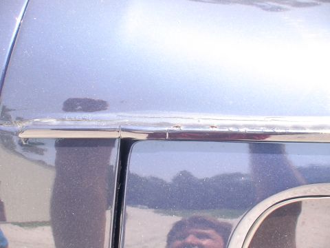 1993 Ford C-350 (Centurion Conversions) - Detail shot of the body trim and door gap on a vehicle.