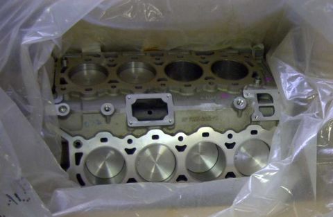 1997 Ford Taurus - Engine block with visible cylinder bores and part numbers, wrapped in protective plastic.