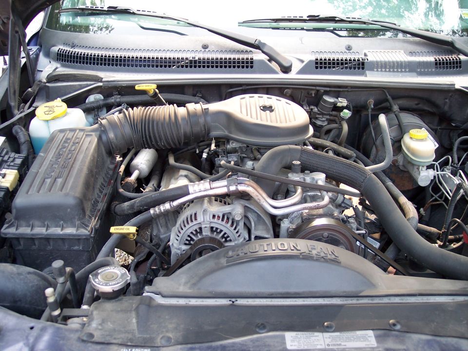Engine bay with air intake, alternator, and fan shroud