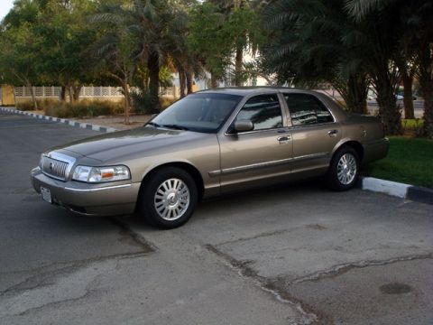 2007 Mercury Grand Marquis - A tan 2007 Mercury Grand Marquis sedan is parked outdoors, showing its front and side profile.