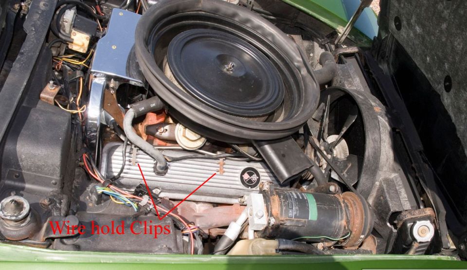 1973 Corvette engine bay with red arrows labeling wire hold clips on the valve cover