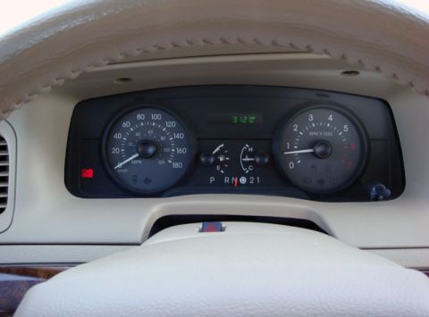 2007 Mercury Grand Marquis - Interior view of an instrument cluster with a round analog speedometer reading in MPH (up to 180) and km/h, a matching tachometer marked RP…