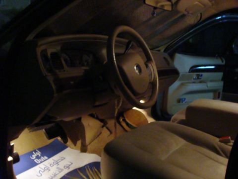 2007 Mercury Grand Marquis - The interior of a 2007 Mercury Grand Marquis is visible, with a blue mat on the floor.