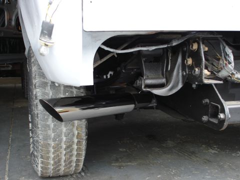 1979 Ford Bronco - Close-up view of the rear tire and exhaust system of a vehicle.