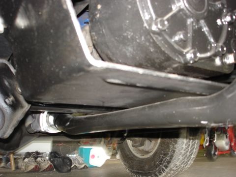1979 Ford Bronco - Close-up of the underside of a vehicle, revealing mechanical parts and suspension elements.