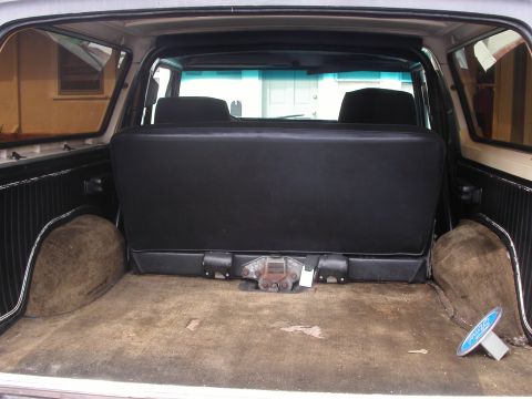 1979 Ford Bronco - The cargo area of a 1979 Ford Bronco features a rear seat and a visible hitch receiver.