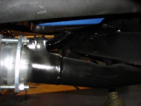 1979 Ford Bronco - Underside view of a vehicle's exhaust system and frame components.