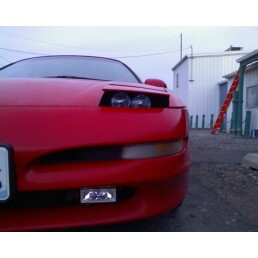 1994 Ford Probe - Front view of a red car with pop-up headlights and a visible license plate.
