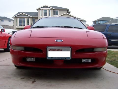1994 Ford Probe - Front view of a red 1994 Ford Probe, its distinctive headlights and Ford emblem. A Washington state license plate is visible.