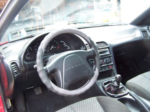 1994 Ford Probe - The interior of a car is shown, the dashboard, steering wheel, and center console.