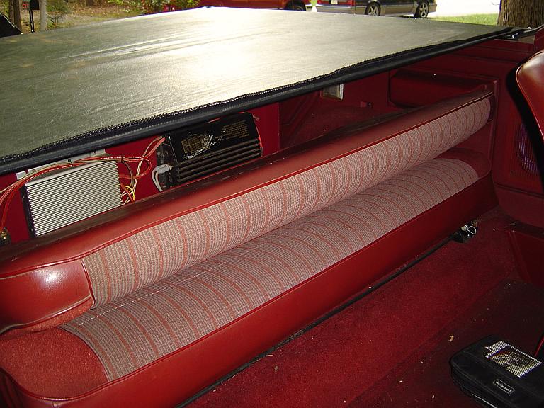 Inside view iew of Bronco with cab bulkhead part of soft top removed but tonneau in place.
