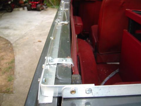 1986 Ford Bronco - The tailgate section is heald in place at each end using a bent piece of aluminum flat stock from Lows.