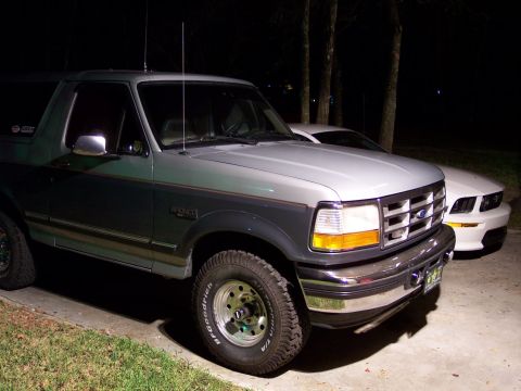 1996 Ford Bronco - This 1996 Ford Bronco features a two-tone paint scheme and is seen parked next to another vehicle.
