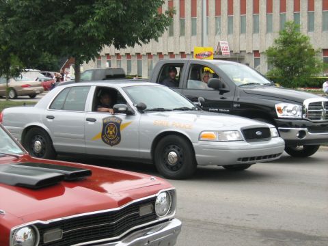 1988 Mercury Grand Marquis - A Michigan State Police car is seen alongside other vehicles during an event.