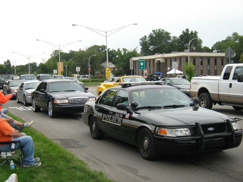 Black police car with push bar, in a line of vehicles