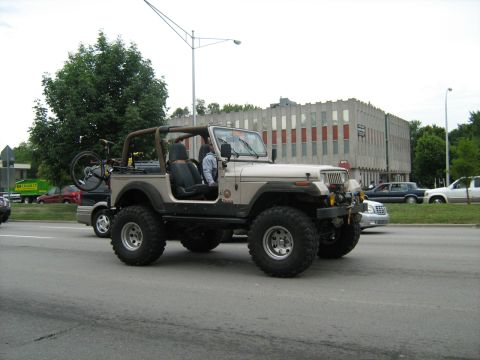 1988 Mercury Grand Marquis - Modified Jeep Wrangler with a bicycle rack is seen on the road.