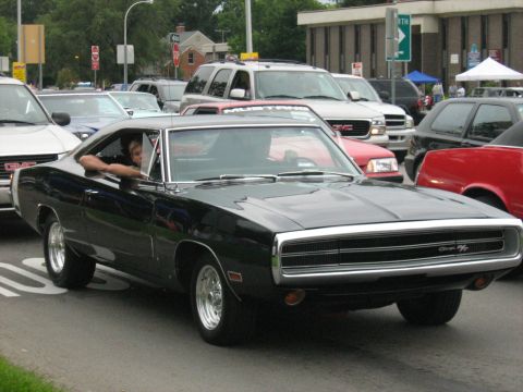 1988 Mercury Grand Marquis - Black 1970 Dodge Charger driving in traffic, Supermotors.net watermark visible.