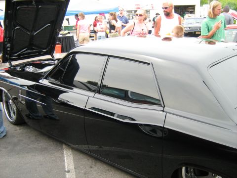 1988 Mercury Grand Marquis - A black sedan is displayed with its hood open, revealing the engine bay.