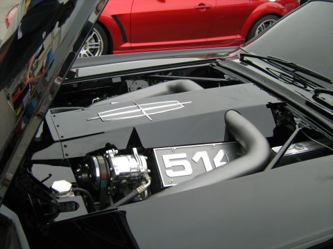 1988 Mercury Grand Marquis - Engine bay details of a black car, with a Lincoln emblem and a license plate visible.