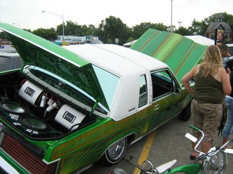 1988 Mercury Grand Marquis - This custom car features extensive audio equipment in its trunk and under the hood, with a distinctive green and white paint scheme.