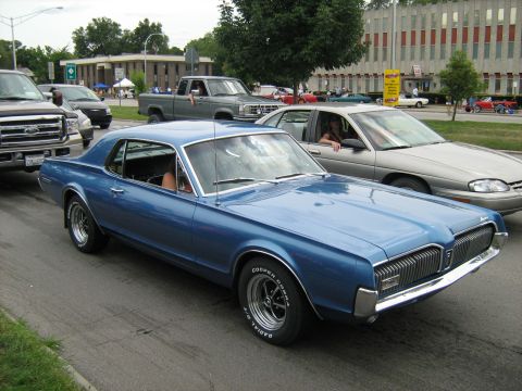 1988 Mercury Grand Marquis - A blue classic coupe is seen in traffic, distinct from the claimed 1988 Mercury Grand Marquis.