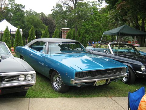 1988 Mercury Grand Marquis - A blue 1968 Dodge Charger is parked next to other classic cars at an outdoor event.