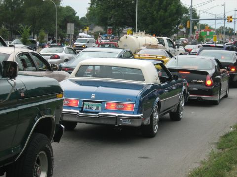 1988 Mercury Grand Marquis - A blue coupe with a white vinyl roof is seen in traffic during the Woodward Cruise 2007.