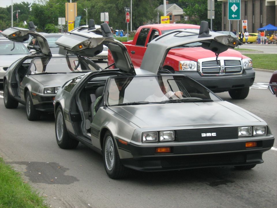 Silver DeLorean DMC-12 with gullwing doors open, front view