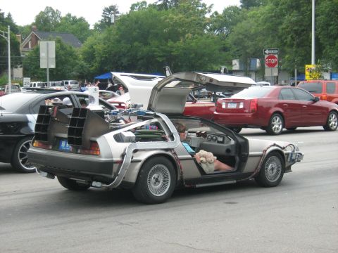 1988 Mercury Grand Marquis - DeLorean DMC-12 seen at an outdoor event, with its iconic doors raised.