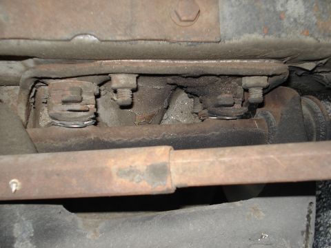 1979 Chevrolet C/K Pickup - Underside view of a vehicle's frame, showing aged bolts and suspension components.