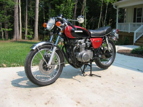 1985 Ford Crown Victoria LTD - Honda CB500 motorcycle with red side covers and black fuel tank.