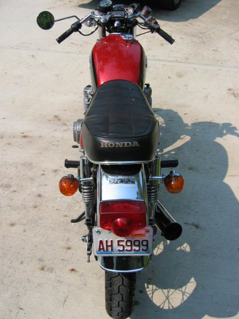 1985 Ford Crown Victoria LTD - This Honda motorcycle, seen from the rear, displays the license plate AH 5999.