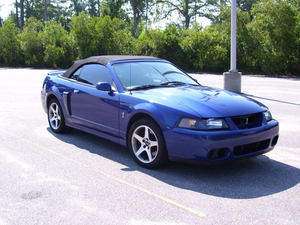 Blue Ford Mustang SVT Cobra convertible parked, front three-quarter view