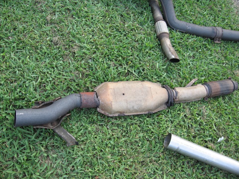 Exhaust catalytic converter and pipe sections on grass