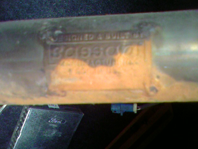 Vehicle identification plate with stamped numbers and text