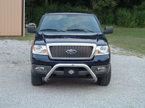2005 Ford F-150 - Frontal view of a 2005 Ford F-150 pickup truck parked on a gravel surface.