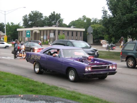 1988 Mercury Grand Marquis - Purple Plymouth muscle car with exposed supercharger blower and Reaper graphics driving down a city street.
