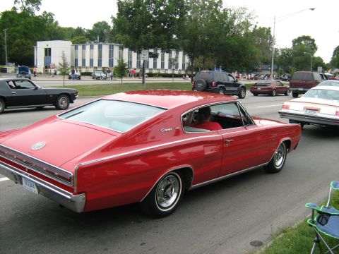 1988 Mercury Grand Marquis - A classic red Dodge Charger is seen in traffic during a car show event.