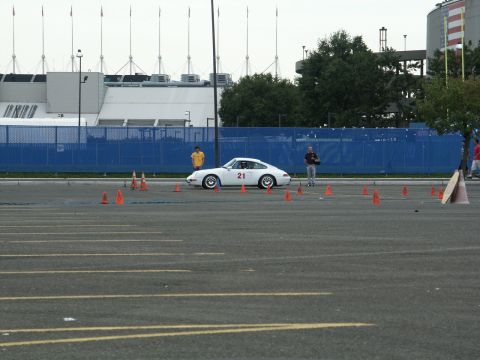 2001 Mercury Grand Marquis - White Porsche 911 with racing number 21 on the door is set up on a course marked by cones.