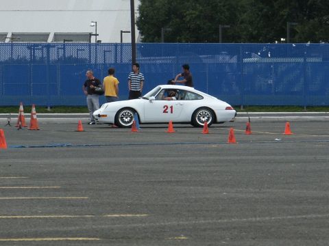 2001 Mercury Grand Marquis - A white coupe with the number 21 displayed on its door is seen on an asphalt lot, possibly during an event.