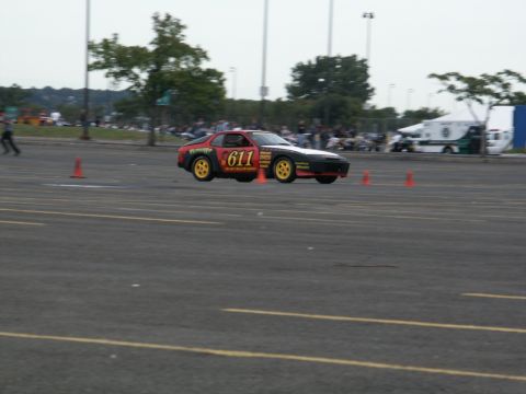 2001 Mercury Grand Marquis - A Porsche 944 with racing decals navigates a course marked by orange cones.