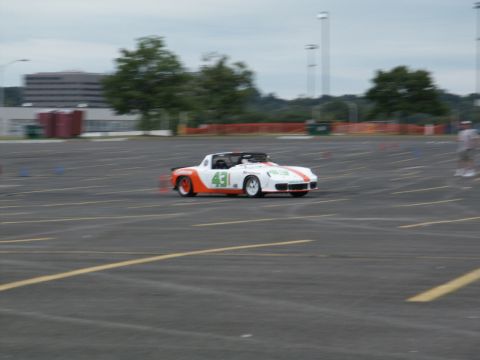 2001 Mercury Grand Marquis - A white and orange sports car, marked with the number 43, navigates a course marked by cones.