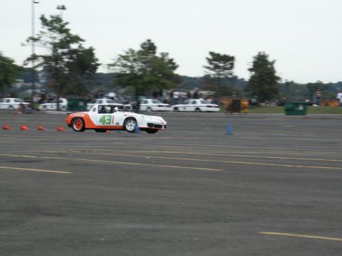 2001 Mercury Grand Marquis - A race car navigates a course marked by orange cones.