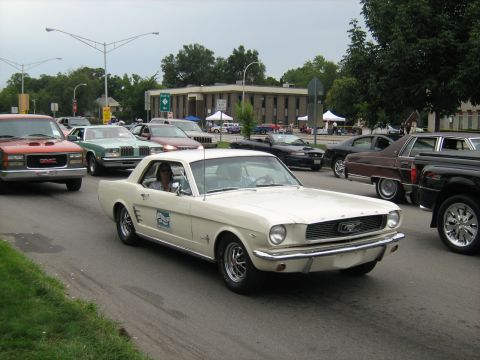 1988 Mercury Grand Marquis - A white 1965 Ford Mustang coupe is seen in traffic during the Woodward Cruise 2007.