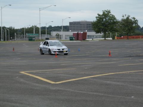 2001 Mercury Grand Marquis - A silver Mitsubishi Lancer Evolution VIII navigates a course marked by traffic cones in an empty parking lot.