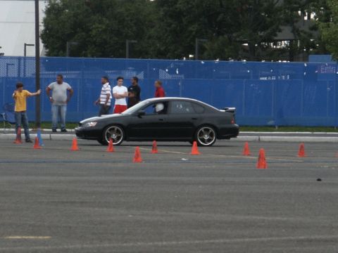 2001 Mercury Grand Marquis - A black sedan is seen on a paved course marked with orange cones, likely during a timed event.