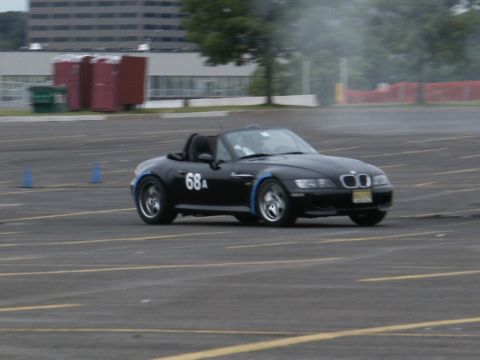 2001 Mercury Grand Marquis - Black convertible sports car with number 68A on the door is seen on a paved lot, possibly during an event.