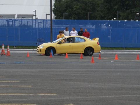 2001 Mercury Grand Marquis - Yellow Dodge Neon SRT-4 navigates a course marked by orange traffic cones.